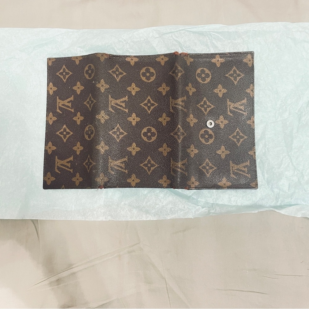 Dark Brown Monogram Trifold with some visible wear and tear